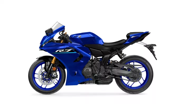 Blue Yamaha R1 sport motorcycle shown in side profile with front disc brakes and windscreen edge.