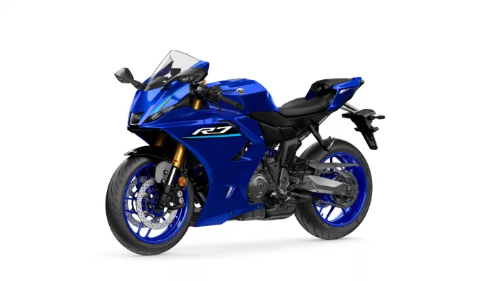 Blue Yamaha sport motorcycle shown from a left-front angle, featuring a blue fairing, windscreen, and gold front forks with prominent R7 branding.