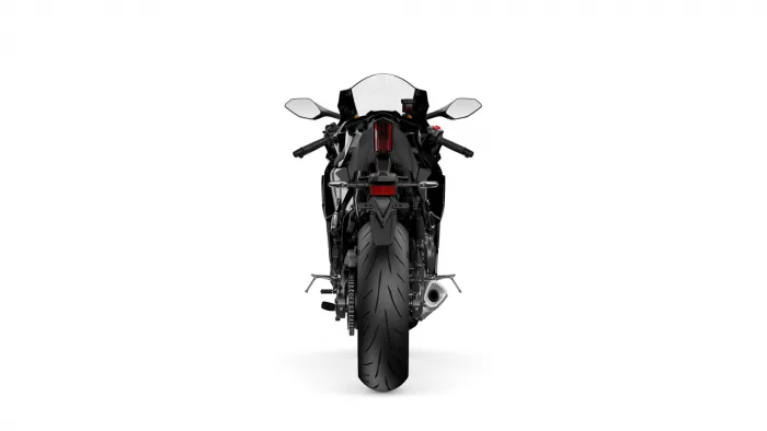 Rear view of a black sport motorcycle on a white background with wheel and taillight visible