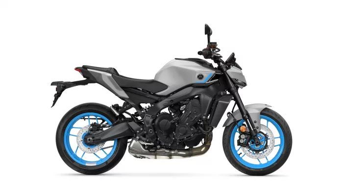 Side profile of a gray sport motorcycle with bright blue rims and black accents