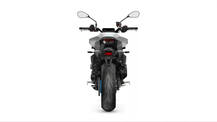 Rear view of a gray sport motorcycle with a large rear tire, taillight, and mirror-equipped handlebars seen from behind