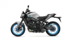 Side view of a silver/gray sport motorcycle with bright blue rims and exposed engine components