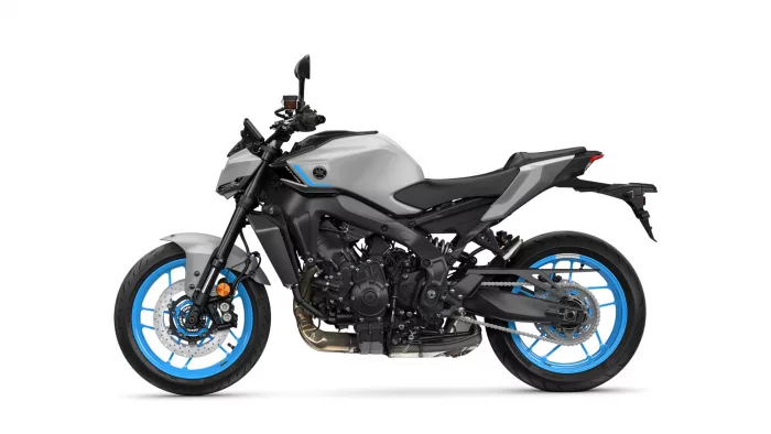 Side view of a silver/gray sport motorcycle with bright blue rims and exposed engine components