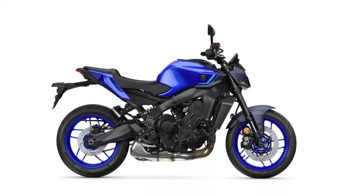 Blue sport motorcycle photographed from the left, showing the blue fuel tank, black frame, and blue rims on a white background.