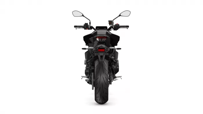 Rear view of a black sport motorcycle showing taillight, license plate area, and a wide rear tire.