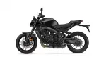 Black sport motorcycle shown in side profile, revealing engine, frame, and disc brakes from the left side on a white background.