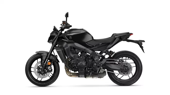 Black sport motorcycle shown in side profile, revealing engine, frame, and disc brakes from the left side on a white background.