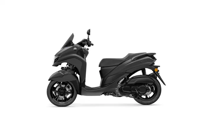 Side view of a black Yamaha scooter showing the front fairing, windshield, and long seat.