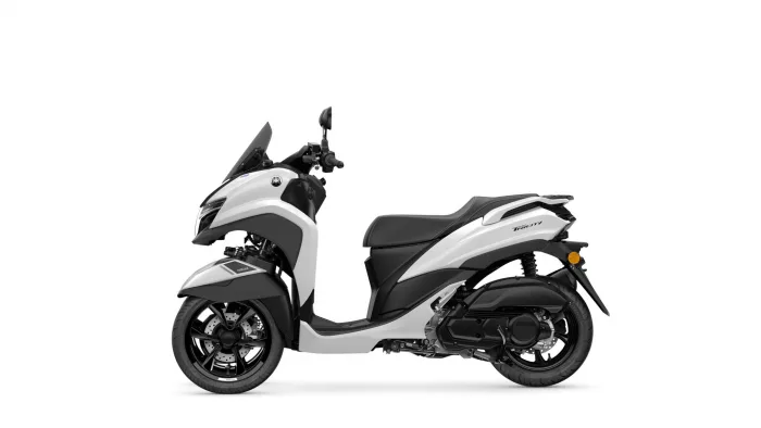 Side view of a white and gray Yamaha Tricity scooter against a white background, showing the front fairing and seat.
