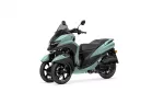 Teal Yamaha three-wheeled scooter with two front wheels and a tall windshield (front-right view)