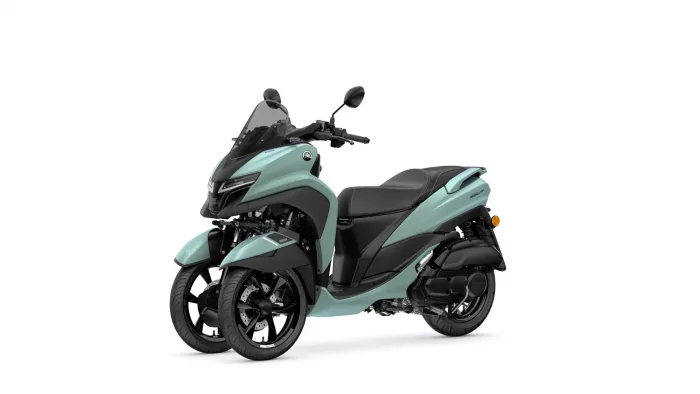 Teal Yamaha three-wheeled scooter with two front wheels and a tall windshield (front-right view)