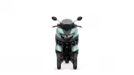 Front view of a teal motorcycle with a dark windscreen and black handlebars, seen head-on.