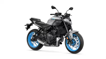 Yamaha MT-07 motorcycle with silver body and bright blue wheels, shown from a front-right side view.