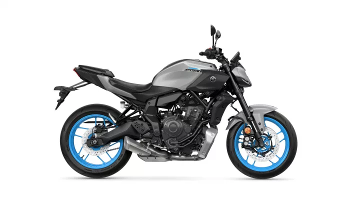 Side view of a grey Yamaha MT-07 sport motorcycle with bright blue wheels and exposed engine components