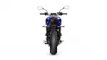Rear view of a blue sport motorcycle, showing taillight, seat, and wide rear tire.