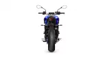 Rear view of a blue motorcycle, showing tail light, seat, and wide rear tire against a white background.