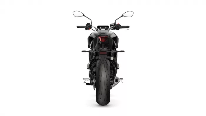 Rear view of a black sport motorcycle on a white background, showing the taillight and wide rear tire