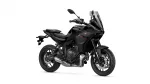 Black Yamaha Tracer sport-touring motorcycle with a tall windshield, shown from a front-left angle