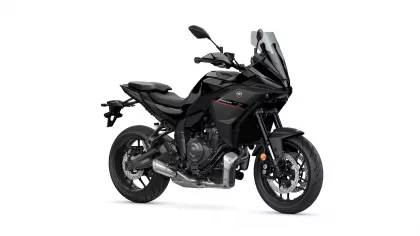 Black Yamaha Tracer sport-touring motorcycle with a tall windshield, shown from a front-left angle