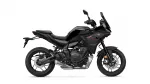 Black sport-tourer motorcycle shown in side profile, featuring a tall windshield and bold angular body panels.