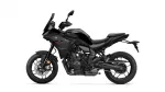 Side view of a black Yamaha Tracer sport motorcycle with sleek bodywork and visible engine components on a white background.