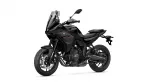 Black Yamaha Tracer sport motorcycle shown from a left-front side angle with a tall windscreen and red accent stripe on the fairing