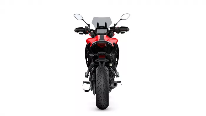Rear view of a red sport motorcycle with black trim, showcasing the tail section, seat, and rear tire on a white background.