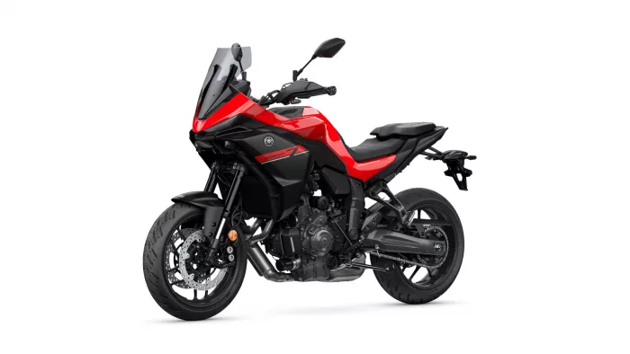 Red and black Yamaha Tracer 7 sport motorcycle, angled side view with windshield and exposed engine details