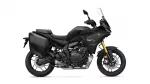 Black Yamaha Tracer GT adventure motorcycle with side panniers and gold front forks, shown in profile.
