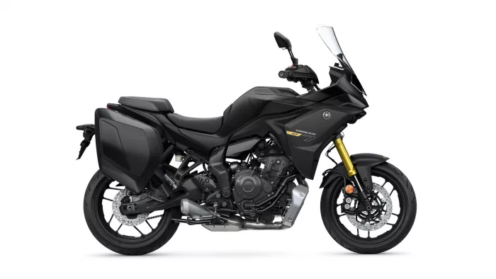 Black Yamaha Tracer GT adventure motorcycle with side panniers and gold front forks, shown in profile.
