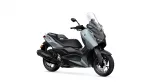 Yamaha XMAX scooter in light gray and black with tall clear windshield, shown from a side-front angle