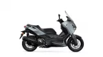 Side view of a gray Yamaha XMAX sport scooter with windshield and black chassis, shown against a white background.