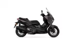 Side view of a black Yamaha sport scooter with a tall windshield against a white background.