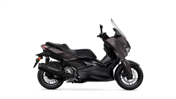 Side view of a black Yamaha sport scooter with a tall windshield against a white background.