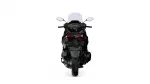 Rear view of a black sport motorcycle with a tall windshield, prominent taillights, and visible rear tire.