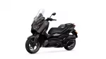 Yamaha XMAX scooter shown from the front-left with a tall clear windshield and dark brown/black body panels.