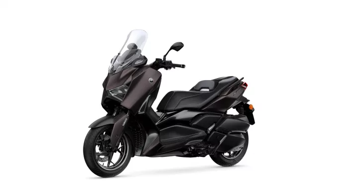 Yamaha XMAX scooter shown from the front-left with a tall clear windshield and dark brown/black body panels.