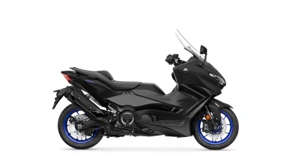 Black Yamaha TMAX scooter in a side view, showcasing its sleek body and blue-rimmed wheels