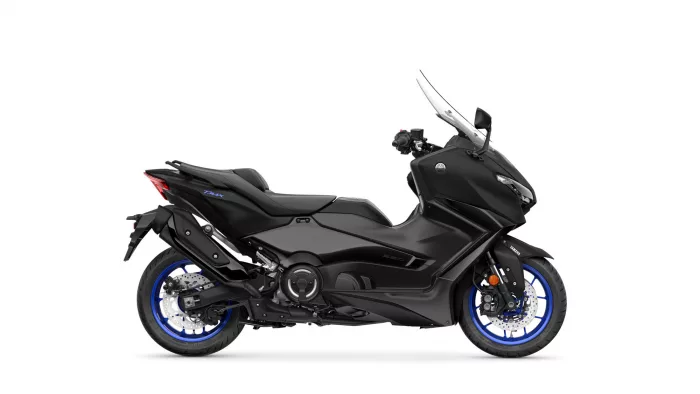 Black Yamaha TMAX scooter in a side view, showcasing its sleek body and blue-rimmed wheels