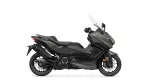 Side view of a matte dark-green Yamaha motorcycle with a tall clear windshield and seat designed for two