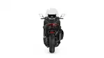 Rear view of a black motorcycle with red taillight against a white background.