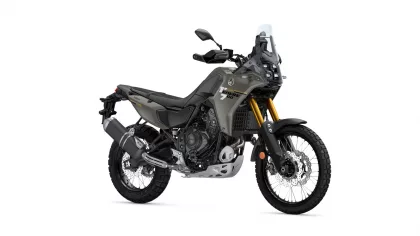 Yamaha Tenere 700 adventure motorcycle photographed from the front-left, gray body with gold front forks on a white background, highlighting its off-road design