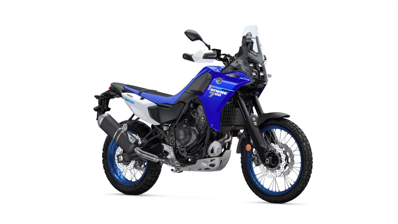 Blue Yamaha adventure motorcycle shown from the side, featuring a tall windscreen and rugged off-road tires (Tenere 700)