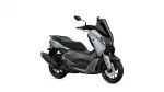 Yamaha NMAX scooter in silver-gray with a tall black windshield, shown from the front-right sideology.