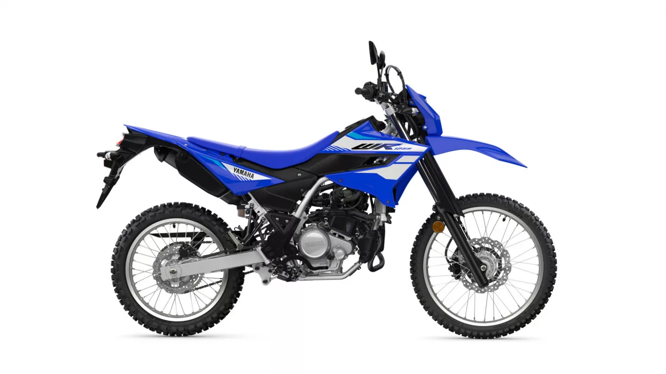 Blue Yamaha dirt bike shown from the side with knobby tires on a white background, highlighting its blue bodywork and graphics.