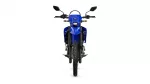 Front view of a blue dual-sport motorcycle, showing the handlebars, headlight, and knobby front tire.