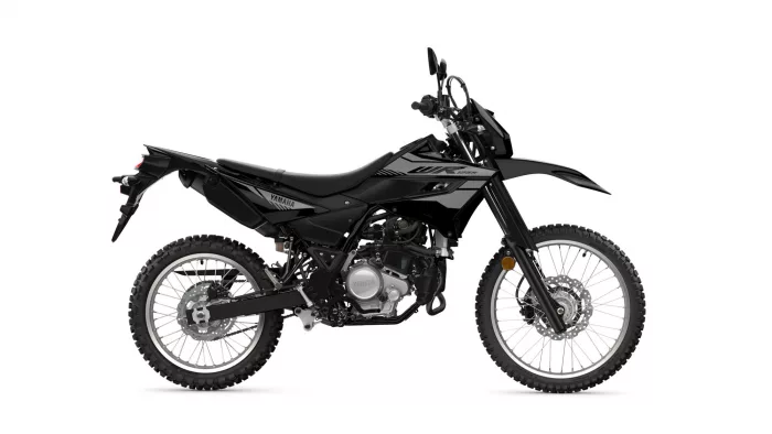 Side view of a black Yamaha dirt bike with knobby tires and raised front fender