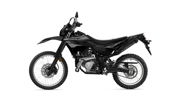 Side view of a black Yamaha dirt bike with knobby tires and exposed engine details.