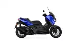 Blue Yamaha XMAX sport scooter viewed from the side, showing the blue body panels, black frame, and large front windshield.