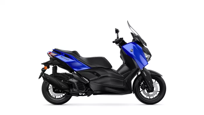 Blue Yamaha XMAX sport scooter viewed from the side, showing the blue body panels, black frame, and large front windshield.